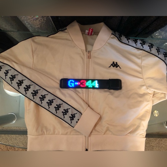 White jacket with symbols along both sleeves. No damage. Light usage. - Picture 2 of 3